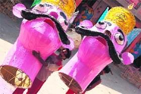 Artists carry effigies of demons at Jammus Geeta Bhawan for the coming Dussehra festival.