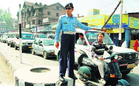 A long queue of traffic waits for the signal to move at a crossing in Lal Chowk, Srinagar. 