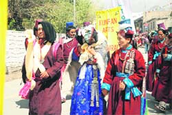 Women don the Ladakhi bridal dress during the inaugural procession of the Ladakh festival. 