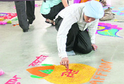 A boy takes part in rangoli contest being held at Punjab College of Technical Education in Ludhiana.