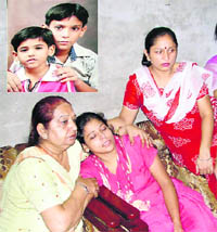 The mother of Aman and Om (inset), who were found murdered on the outskirts of Moga, is consoled by relatives on Friday.