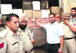 SHO sadar shows the seized wine boxes. 