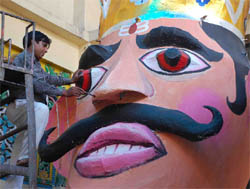 An artist gives final touches to a Ravan idol in Faridabad on Saturday.