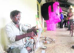 Shaukat Ali prepares effigies for Dussehra in Dehradun on Saturday.