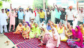 Residents of BRS Nagar stage dharna at the Sarabha Nagar police station in Ludhiana on Saturday. 
