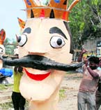 Artistes carry an effigy of Ravana to Dussehra Grounds in Karnal on Sunday.