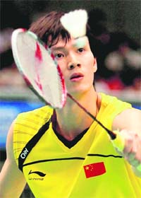 Chinas Bao Chunlai returns the shuttle against Indonesias Taufik Hidayat during their men's singles final in the Japan Open in Tokyo