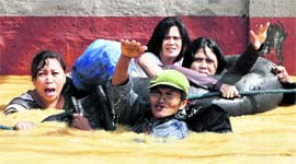 Residents wait to be evacuated in Cainta Rizal, east of Manila, on Sunday.