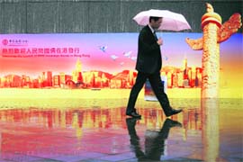 A man walks past a Bank of China billboard welcoming the launch of Chinas RMB sovereign bonds in Hong Kong on Monday. Chinas finance ministry will issue 6 billion yuan ($878 million) in yuan-denominated bonds, its first such issue and a key step in the gradual internationalisation of the Chinese currency. 