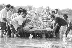 Devotees immerse Durga’s idol in the Ghaggar at Panchkula