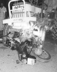 The mangled remains of a motorcycle that collided with a tractor-trailer on the Dera Bassi-Barwala road