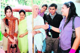 Students from Pakistan interact with a man dressed up as Mahatma Gandhi during the international peace fest held at DAV College in Chandigarh