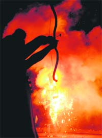The silhouette of Lord Ram against the burning effigy of Ravana during Dasehra celebrations at Sector 46, Chandigarh
