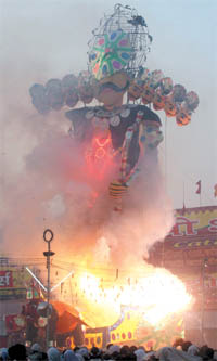 An effigy of demon king Ravan being burnt at Subhash Maidan on Dussehra in New Delhi on Monday.