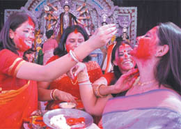 Bengali women apply vermillion on one another at Aram Bagh Durga Puja Samiti.