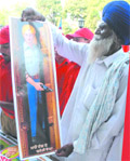 Drawing inspiration: An elderly man looks at a poster of Shaheed Bhagat Singh on his birth anniversary at Desh Bhagat Yaadgar Hall in Jalandhar.