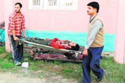 Villagers carry the body of a militant killed during an encounter at Tral in Srinagar on Monday.