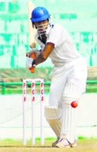 A player of IOC plays a shot at the PCA Stadium in Mohali on Monday.