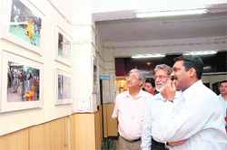 Garhwal Commissioner Uma Kant Panwar (right) along with other visitors at a photo exhibition at Uttaranchal Gramin Bank in Dehradun 