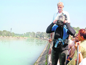 A BBMB diver preparing himself to search the body of the boy who fell into the canal near Sundernagar on Monday. 