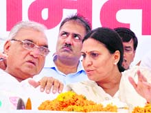 Chief Minister Bhupinder Singh Hooda with Congress nominee and sitting MLA from Karnal Sumita Singh at a public meeting in Karnal on Tuesday. 