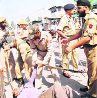 policemen shift an injured protester
