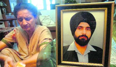 Deepinder Kour sits dejected with murdered son Amandeeps photograph at her residence in Shastri Nagar, Jammu