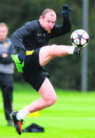 Manchester Uniteds Wayne Rooney jumps for the ball during a training session in Manchester on Tuesday.  Reuters