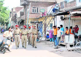 Policemen patrol New Indira Colony on Wednesday. 