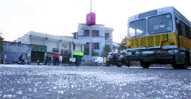 Pieces of glass litter the road after an accident in Karol Bagh, New Delhi, on Wednesday.