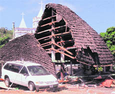 A destroyed structure is seen among the debris near a church following a tsunami in the village of Leone, American Samoa, on Tuesday.