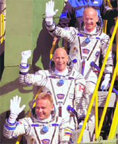 Canadian billionaire and Quebec-born philanthropist Guy Laliberte (centre), Russian cosmonaut Maxim Surayev (bottom) and US astronaut Jeffrey Williams, crewmembers of the 21st mission to the International Space Station, gesture prior to the launch of Soyuz-FG rocket at the Baikonur Cosmodrome in Kazakhstan on Wednesday. Laliberte is due to stay at the space station for nine days, before returning to earth on a Soyuz capsule on October 11. Surayev and Williams will remain on the station until March 2010. 
