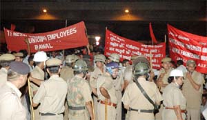 Policemen control industrial workers protesting in Gurgaon on Thursday.