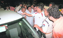 SSP Sanjay Gunjiyal inspects the car of the BJP leader that was shot at in Haridwar
