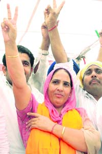 SAD candidate from Ambala City Charanjit Kaur Malour flashes the victory sign at a rally in Ambala