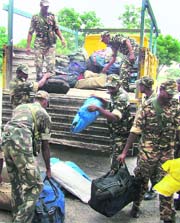  Security personnel who arrived on election duty unload their luggage in Karnal on Thursday.