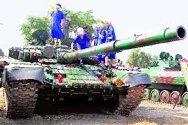 Jawans show a tank to students of Miri Piri Academy on the 46th raising day of the Panther Division in Amritsar cantonment on Thursday.