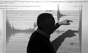 German seismologist Winfried Hanka shows a graph registered during the earthquake in the Pacific off the Samoa islands