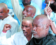 Cleaning staff with tonsured heads during a protest organised under the banner of the Akhil Bharatiya Safai Kaamgar Parishad demand abolition of contract system, at Jantar Mantar in New Delhion Friday.