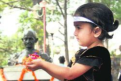 A little girl garlanding the statue of the Mahatma on the Gandhi Jayanti at Dharamsala