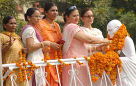 Jasleen Sethi, district president of the Mahila Congress, garlands an idol of Mahatma Gandhi on his birth anniversary in Jalandhar on Friday.