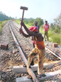 Workers carry out repairs on the track where two coaches of a DMU train derailed at Bajalta near Jammu