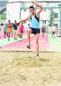 An athlete takes part in long jump in the Ludhiana District Athletics Championship held at Guru Nanak Stadium on Friday. 