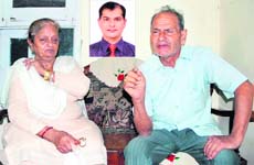 The parents of Raman Joshi (inset) in Jalandhar. 