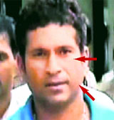 A TV grab shows Sachin Tendulkar arriving at Chatrapati Shivaji International Airport in Mumbai on Friday. Sachins left cheek and eye appear swollen.