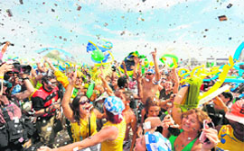 A cheerful crowd celebrates in Copacabana Beach in Rio de Janeiro, Brazil as it is officially announced that their hometown will stage the 2016 Olympic Games on Friday.