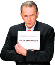 IOC president Jacques Rogge shows the card containing the name of the winning city, Rio de Janero on Friday.