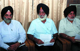 Chairman of the Punjab State Electricity Board HS Brar (centre) interacts with media in Bathinda on Saturday.
