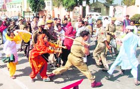 Policemen lathicharge youths protesting against the opening of a CBI office in the Residence area in Srinagar