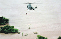 An IAF helicopter lifts a man in Raichur district of Karnataka